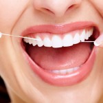 Woman flossing her teeth